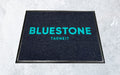 Blue and denim inlay custom logo mat for a restaurant.