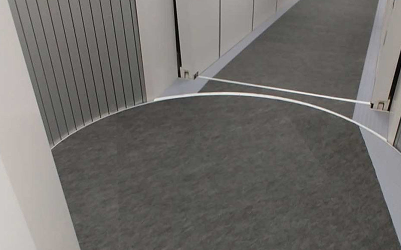 Grey SmartGrip Mats used in a passenger boarding bridge in an airport.