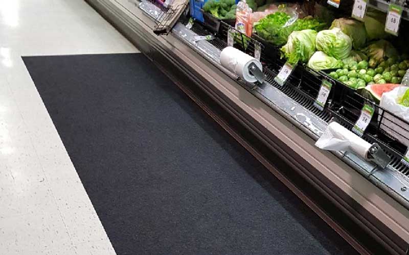 Insitu product image of black, non-slip SmartGrip Matting in fresh produce area of supermarket.