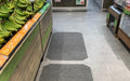 Insitu product image of grey, non-slip SmartGrip Matting in fresh produce area of supermarket.