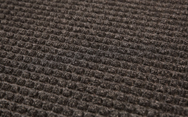 Close up product image of charcoal, polypropylene Waterhog Classic Mat made for commercial and residential entrances